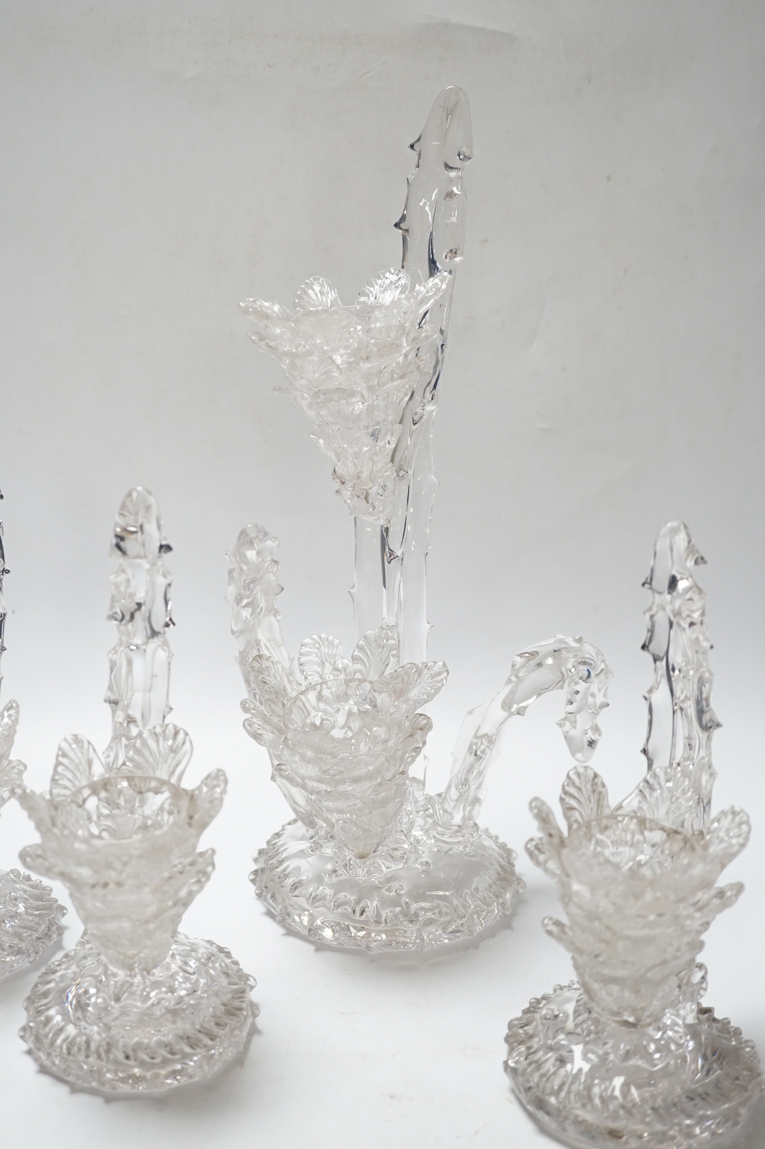 A set of four glass stylistic floral candlesticks, (one double holder the other three single holder), tallest 33cm high